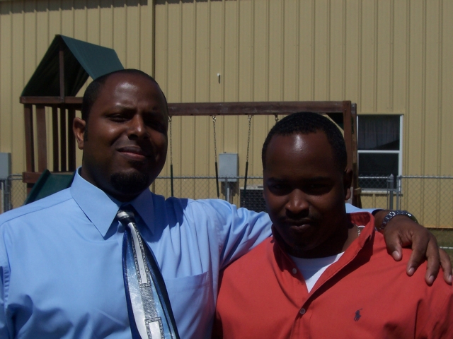 Larry Dacus Jr. (on right, orange shirt), grandson of Louis Joiner.